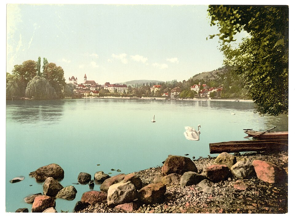Nineteenth-century colour photochrom view of the Swiss town of Thun with its castle towers above the lake