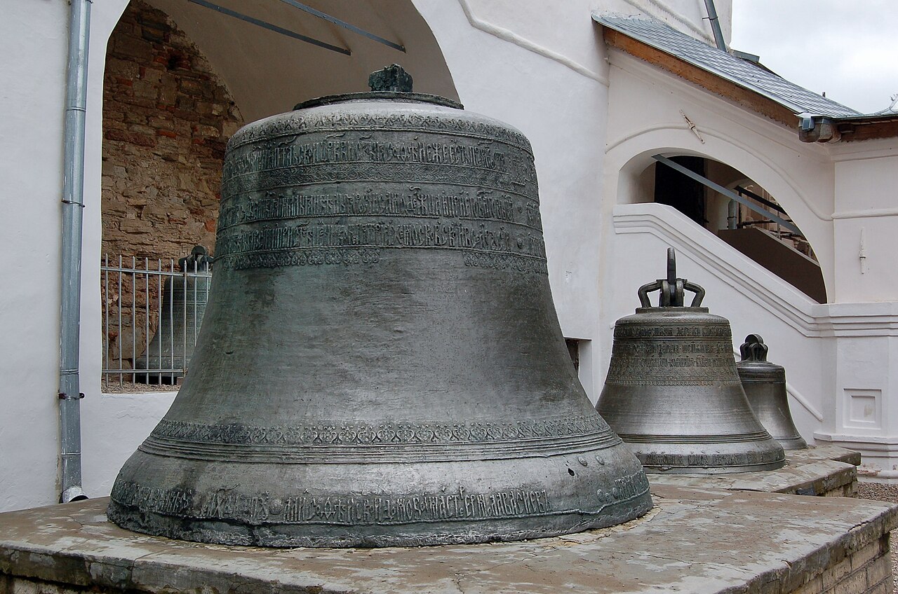Large historic bronze bells with Slavonic inscriptions standing outside the Saint Sophia Cathedral belfry in Novgorod, Russia