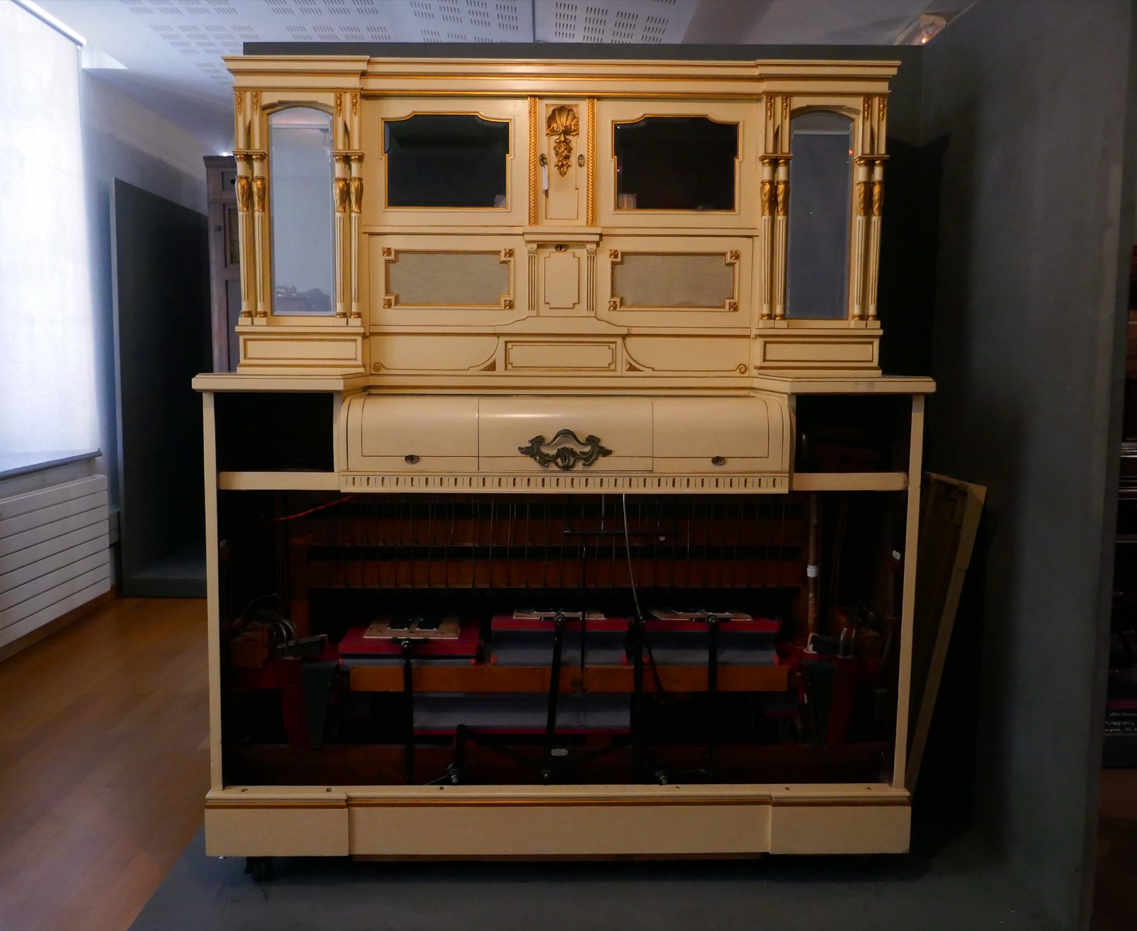 A Welte-Mignon reproducing player piano on museum display with its paper-roll mechanism visible