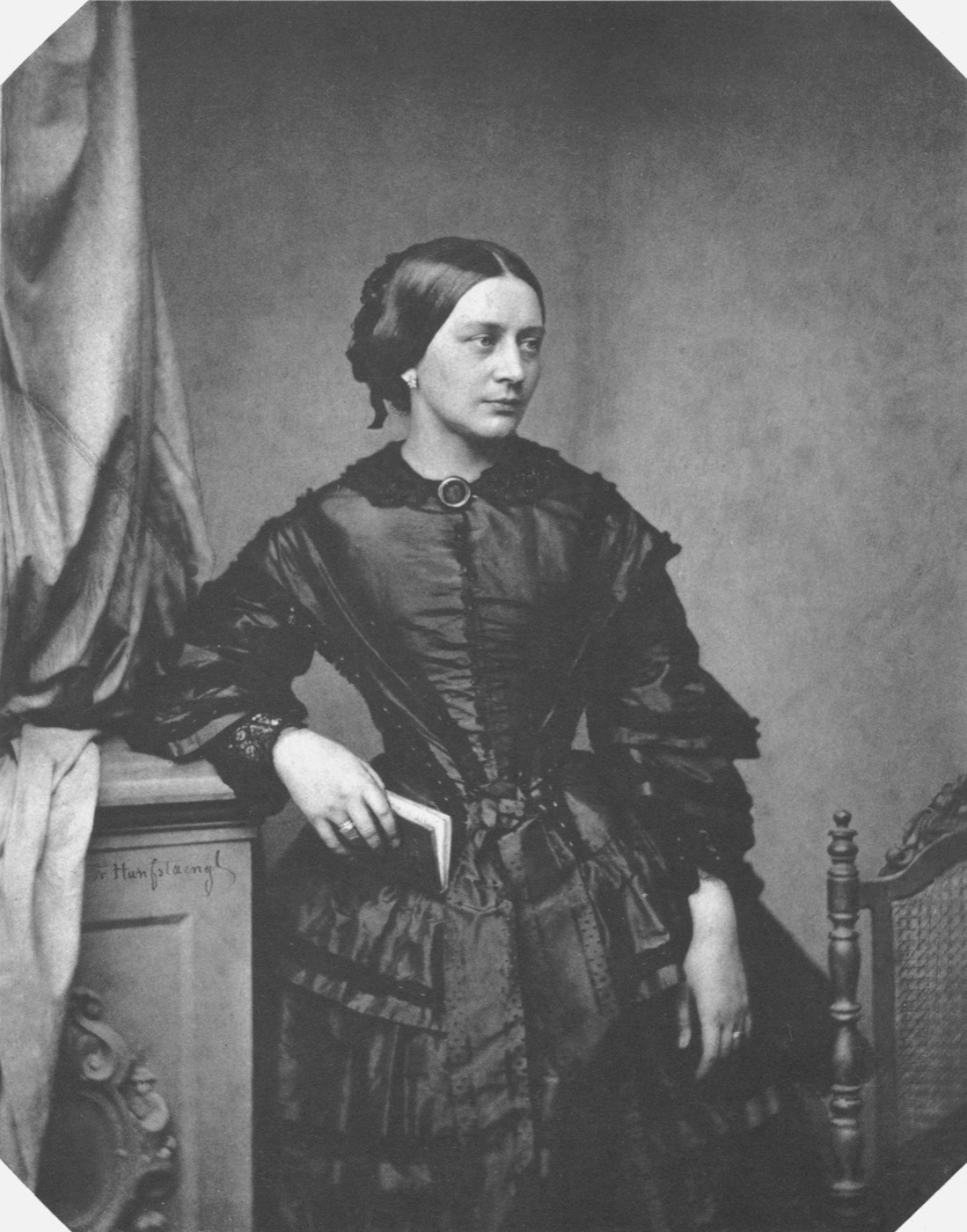 Photographic portrait of pianist Clara Schumann in a dark dress, taken by Franz Hanfstaengl