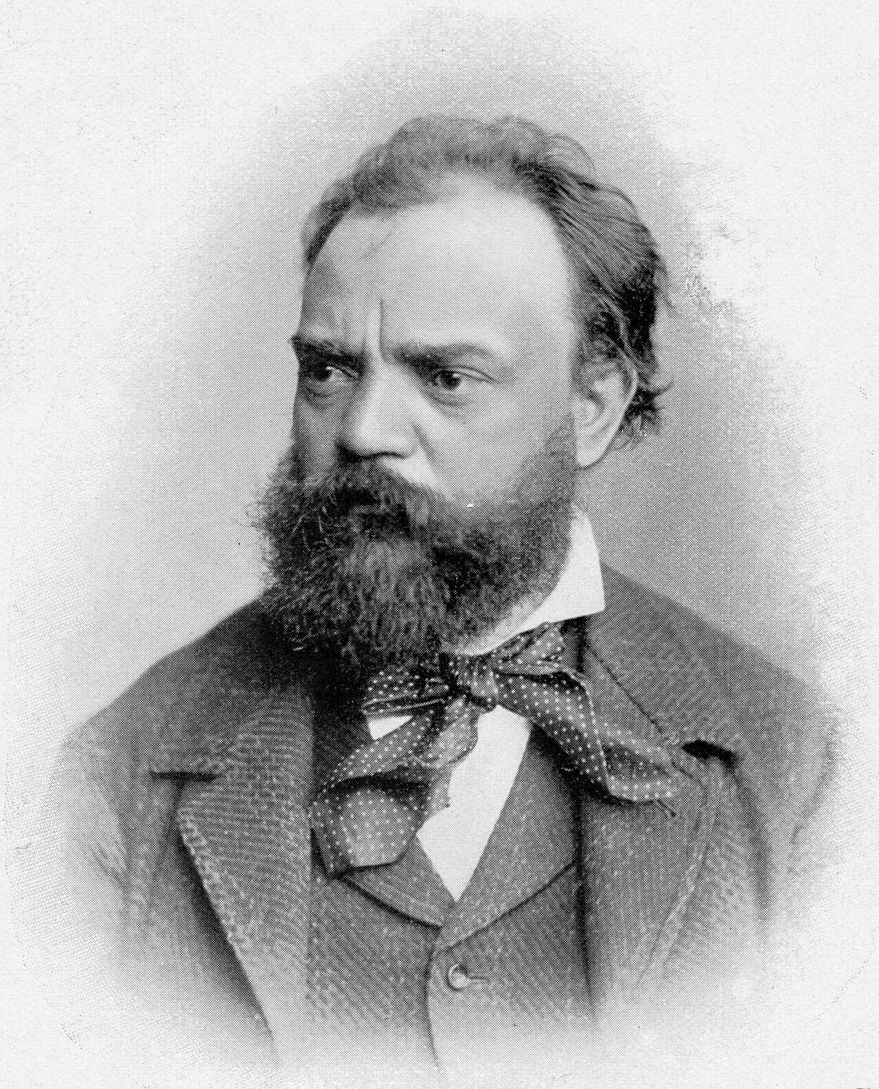 Black-and-white photographic portrait of the composer Antonín Dvořák, bearded, in formal dress