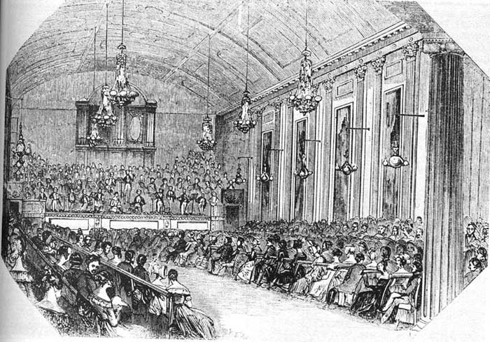 Engraving of a crowded concert in the Hanover Square Rooms, London, with an orchestra on a raised platform