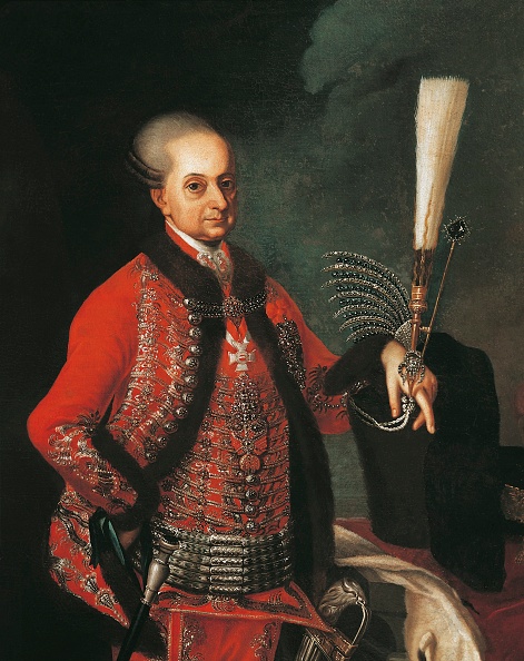 Eighteenth-century portrait painting of Prince Nikolaus I Esterhazy in red court dress holding a plumed hat
