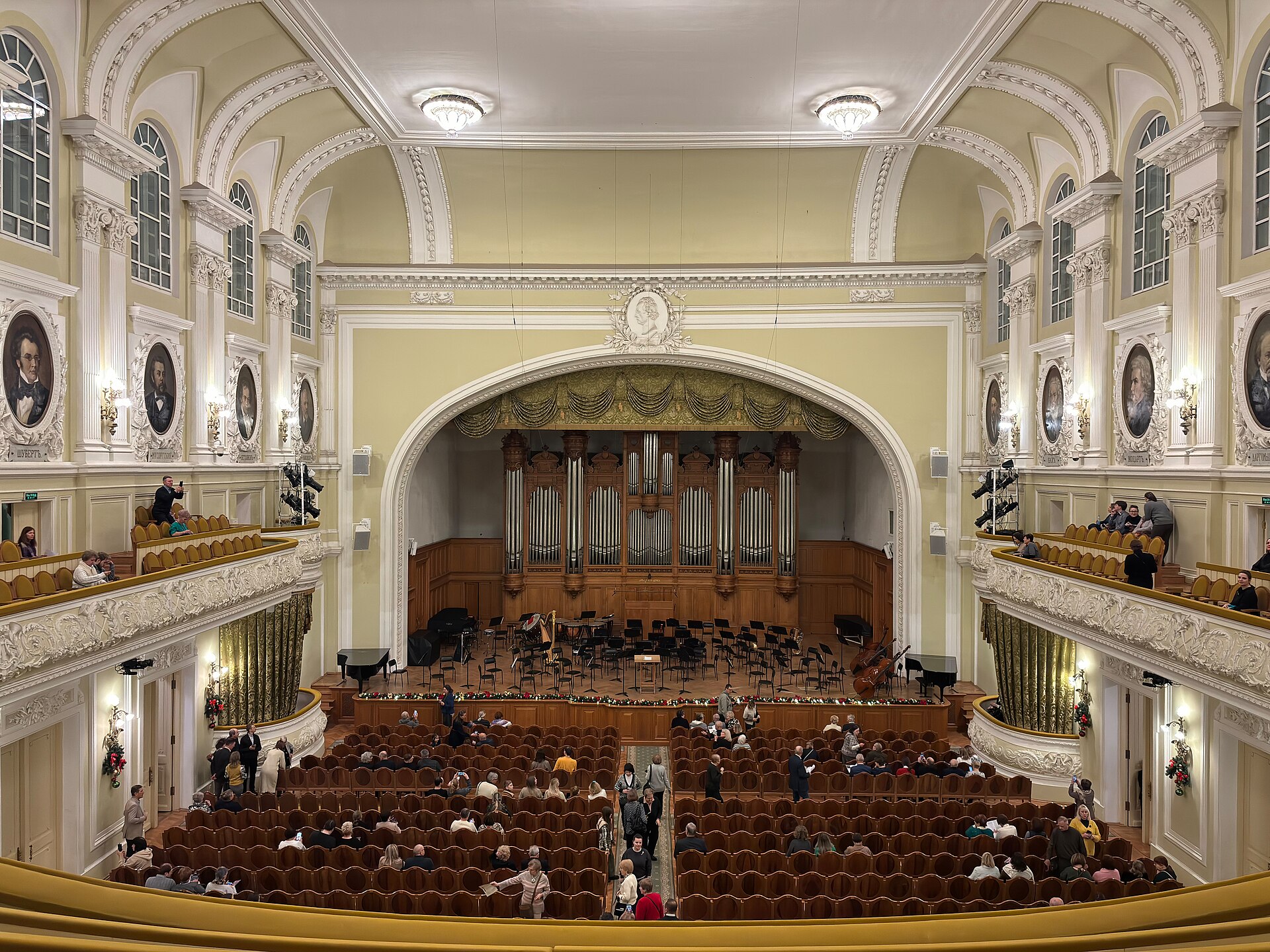 Interior of the Great Hall of the Moscow Conservatory, showing the organ, tiered seating and the composer portraits along the side walls