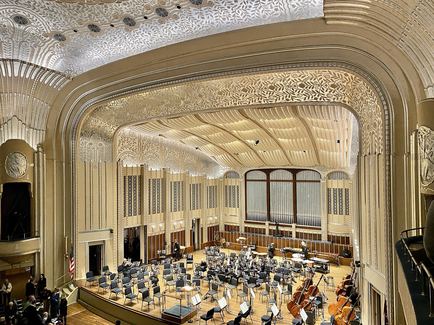 Interior of Severance Hall in Cleveland, with the Cleveland Orchestra on stage and the Art Deco proscenium above them