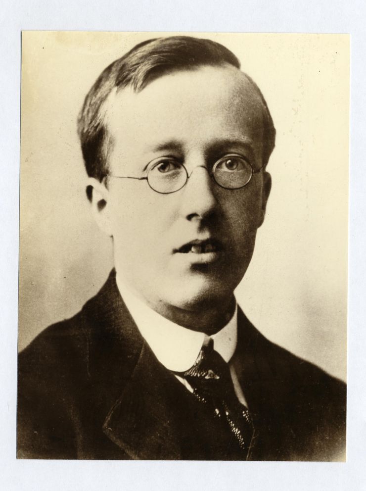 Sepia portrait photograph of the English composer Gustav Holst in 1901, wearing glasses and a formal jacket